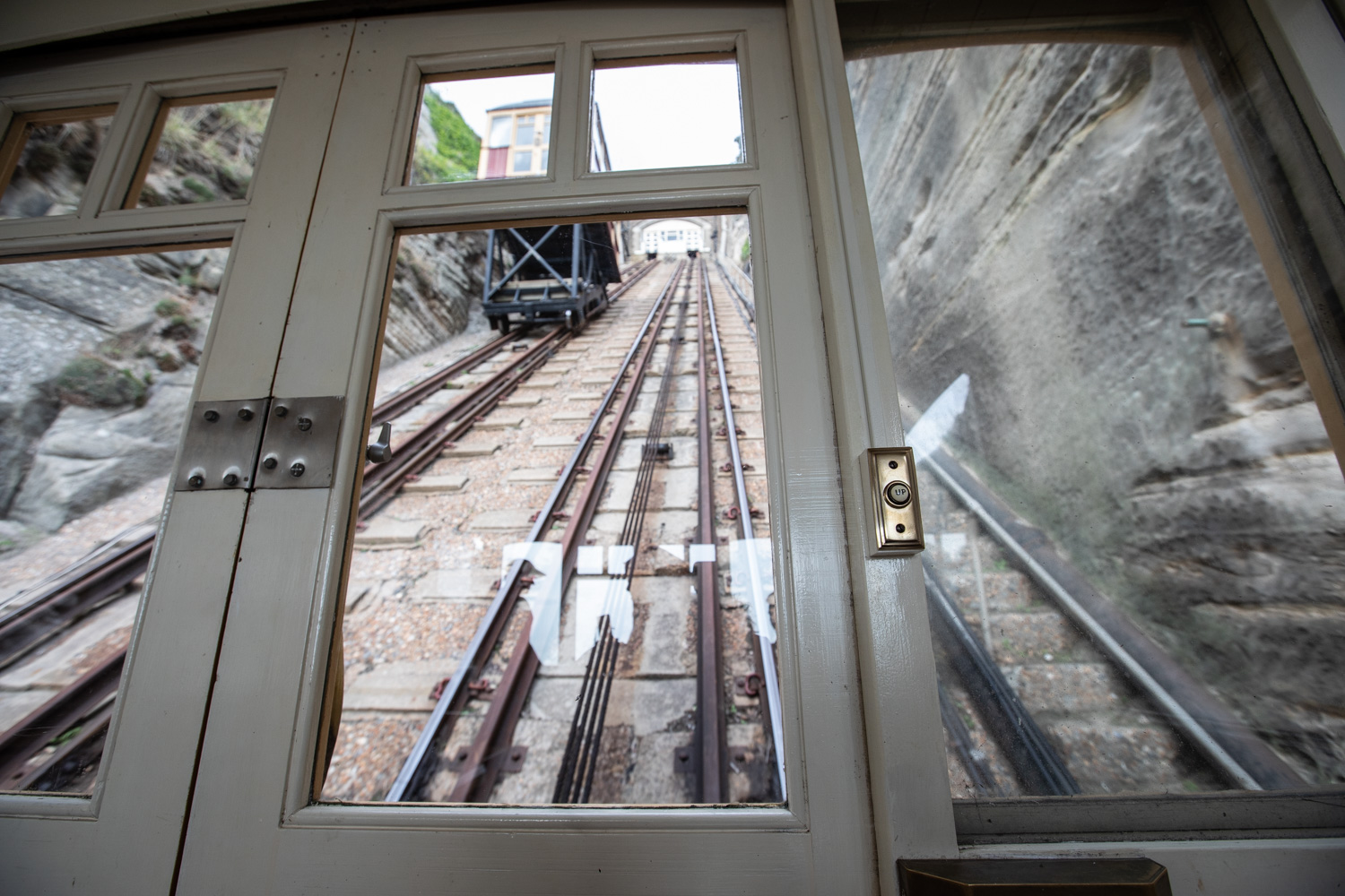 An image of the East Hill funicular lift in Hastings. The photographer is inside the lift at the bottom of the lift, taking a photo of the view up. 